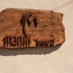 Wooden carved signage of Manili Bistro