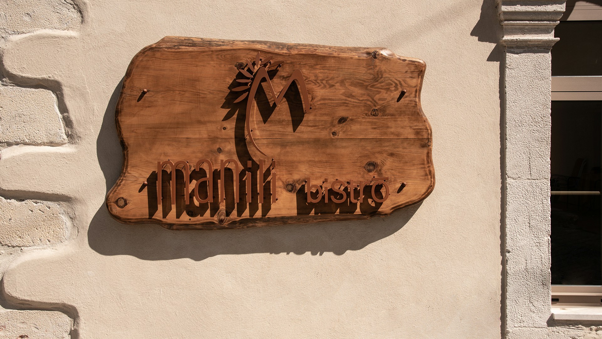 Wooden carved signage of Manili Bistro