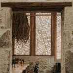 Stone-framed view of the bar area in Manili Bistro