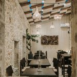 Stone-framed view into Manili Bistro dining area